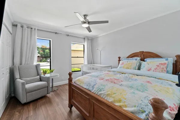 a bedroom with a bed and wooden floor