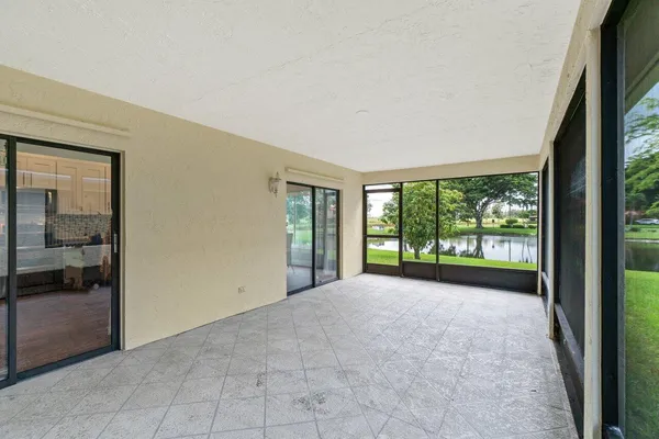 a view of a big room with windows and yard