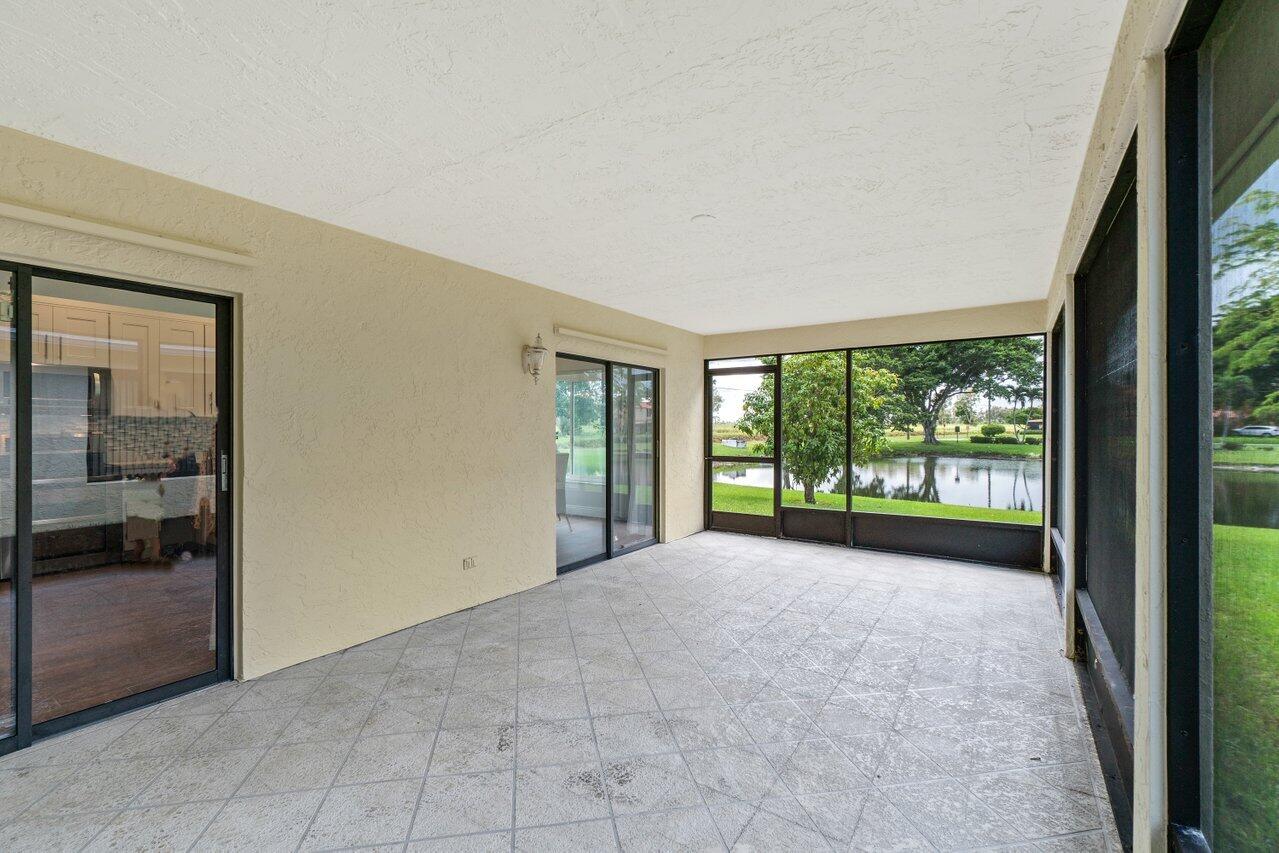19977 Villa Medici Place Boca Raton, FL 33434 - Photo 26 of 33 a view of a big room with windows and yard