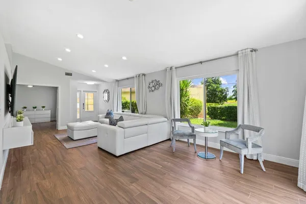 a living room with furniture and a large window