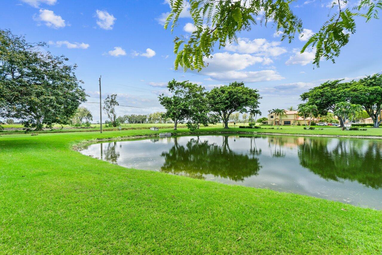 19977 Villa Medici Place Boca Raton, FL 33434 - Photo 32 of 33 a view of a lake with a yard