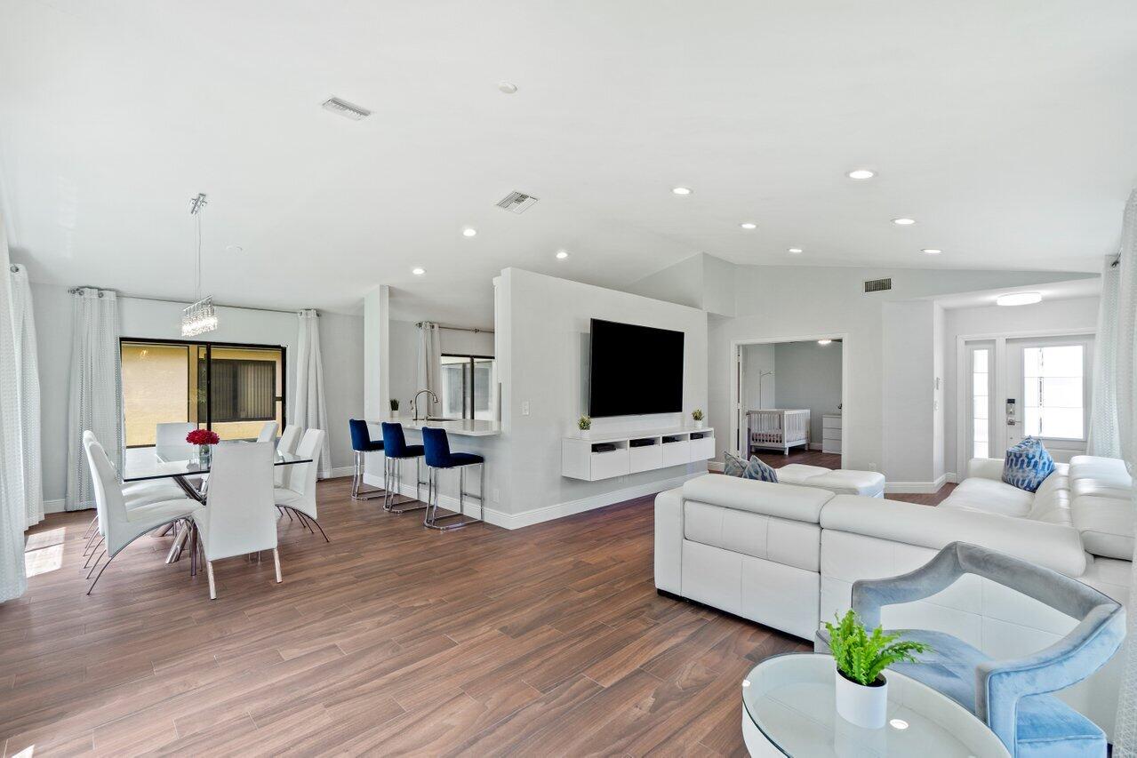19977 Villa Medici Place Boca Raton, FL 33434 - Photo 4 of 33 a living room with furniture flat screen tv and wooden floor