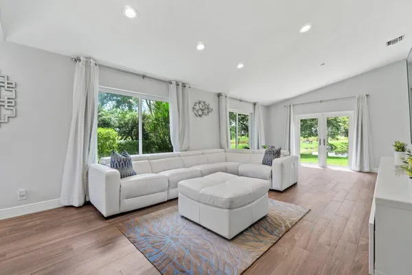 a living room with furniture and a large window