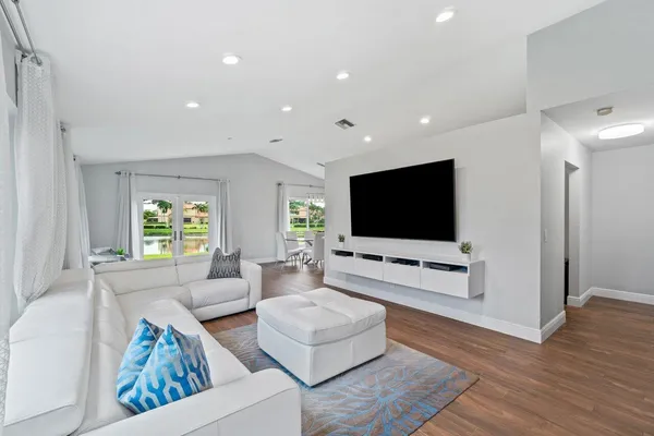 a living room with furniture and a flat screen tv