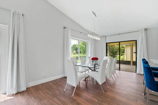 a view of a dining room with furniture window and wooden floor