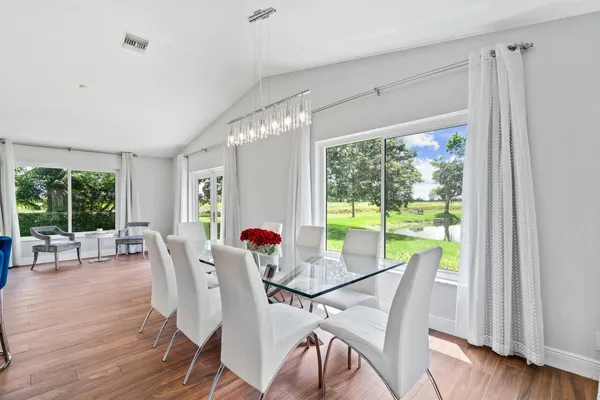 a view of a dining room with furniture window and wooden floor