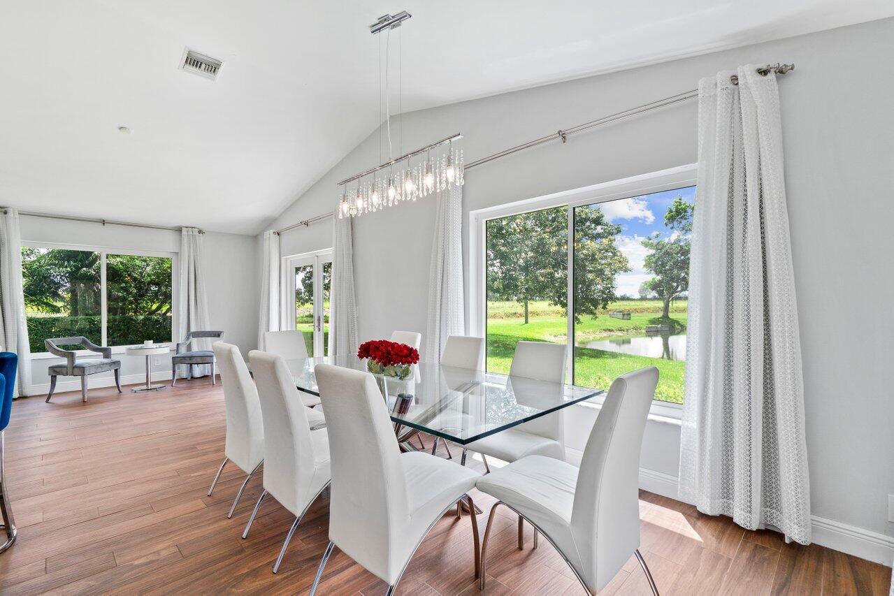 19977 Villa Medici Place Boca Raton, FL 33434 - Photo 8 of 33 a view of a dining room with furniture window and wooden floor