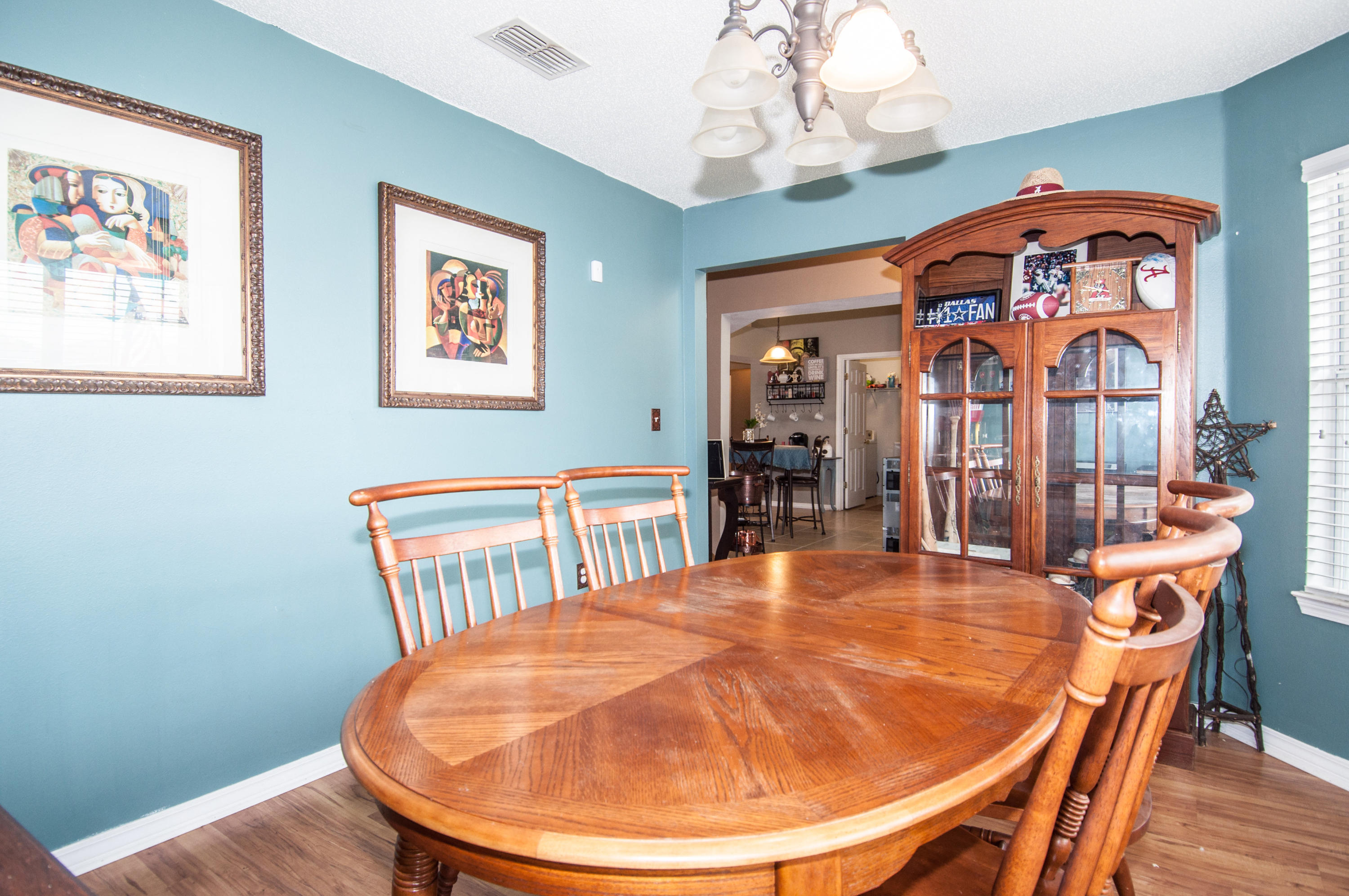 210 Limestone Circle Crestview, FL 32539 - Photo 25 of 54 a view of a dining room with furniture wooden floor and a chandelier