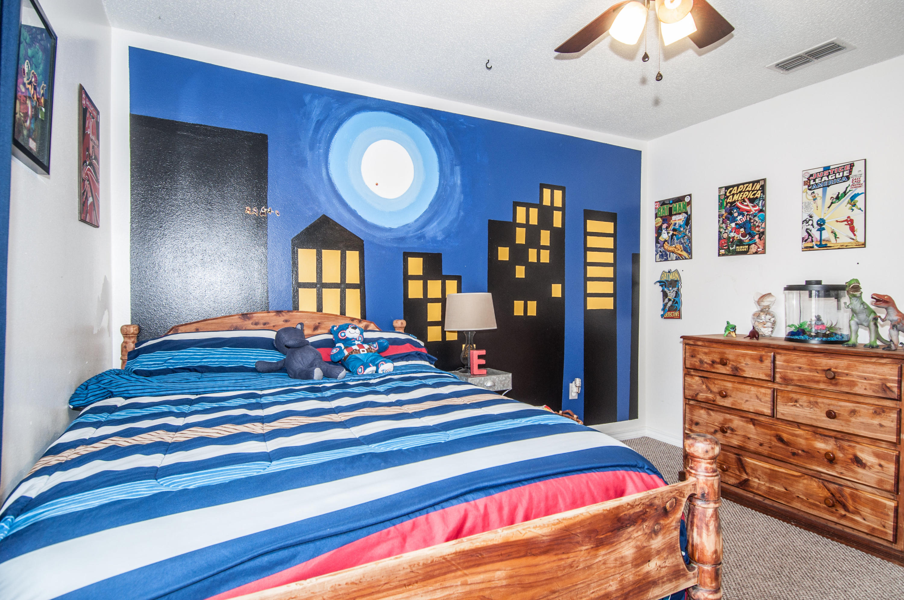 210 Limestone Circle Crestview, FL 32539 - Photo 29 of 54 a spacious bedroom with a bed and a chandelier