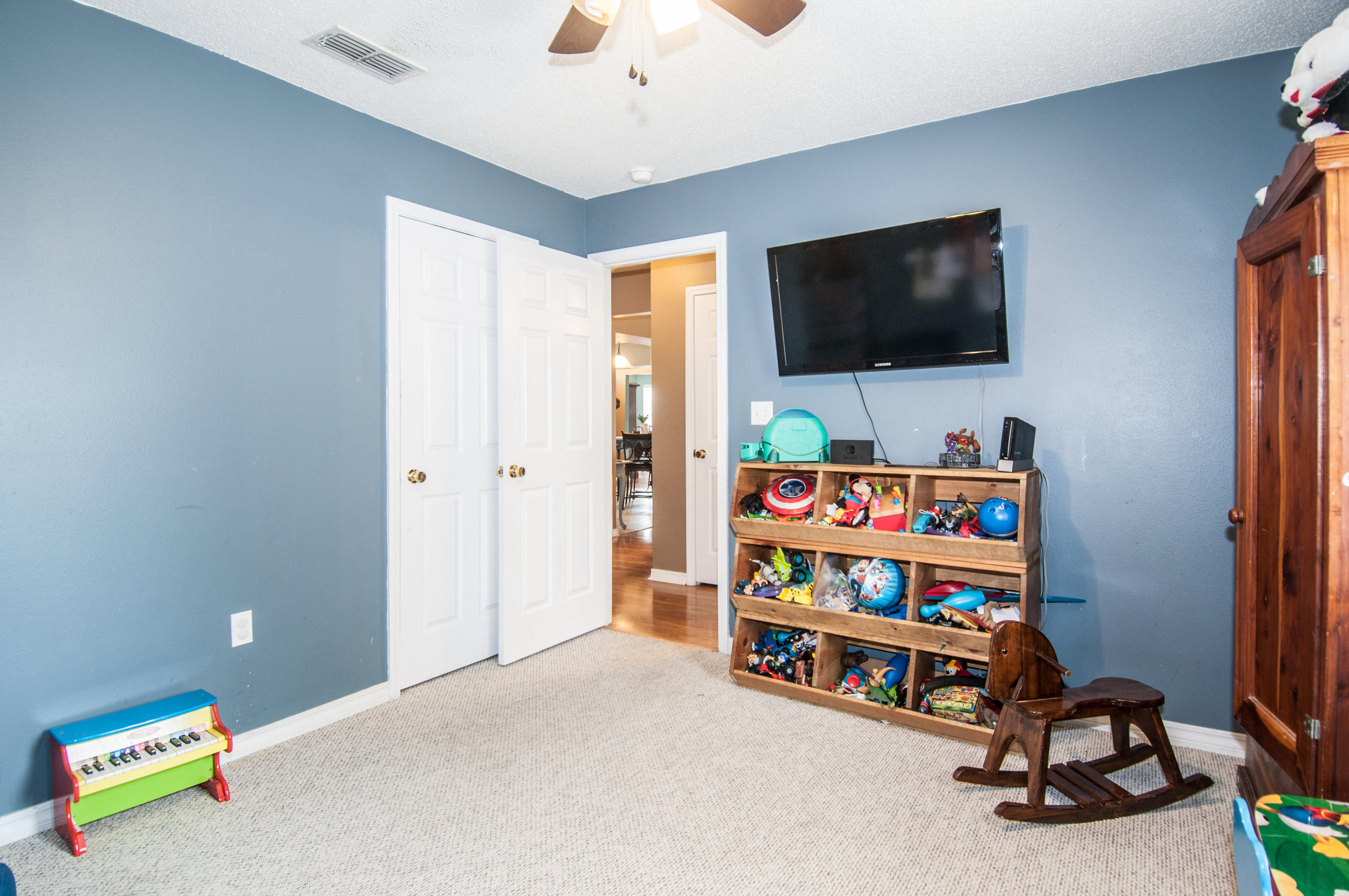 210 Limestone Circle Crestview, FL 32539 - Photo 35 of 54 a living room with furniture and a flat screen tv