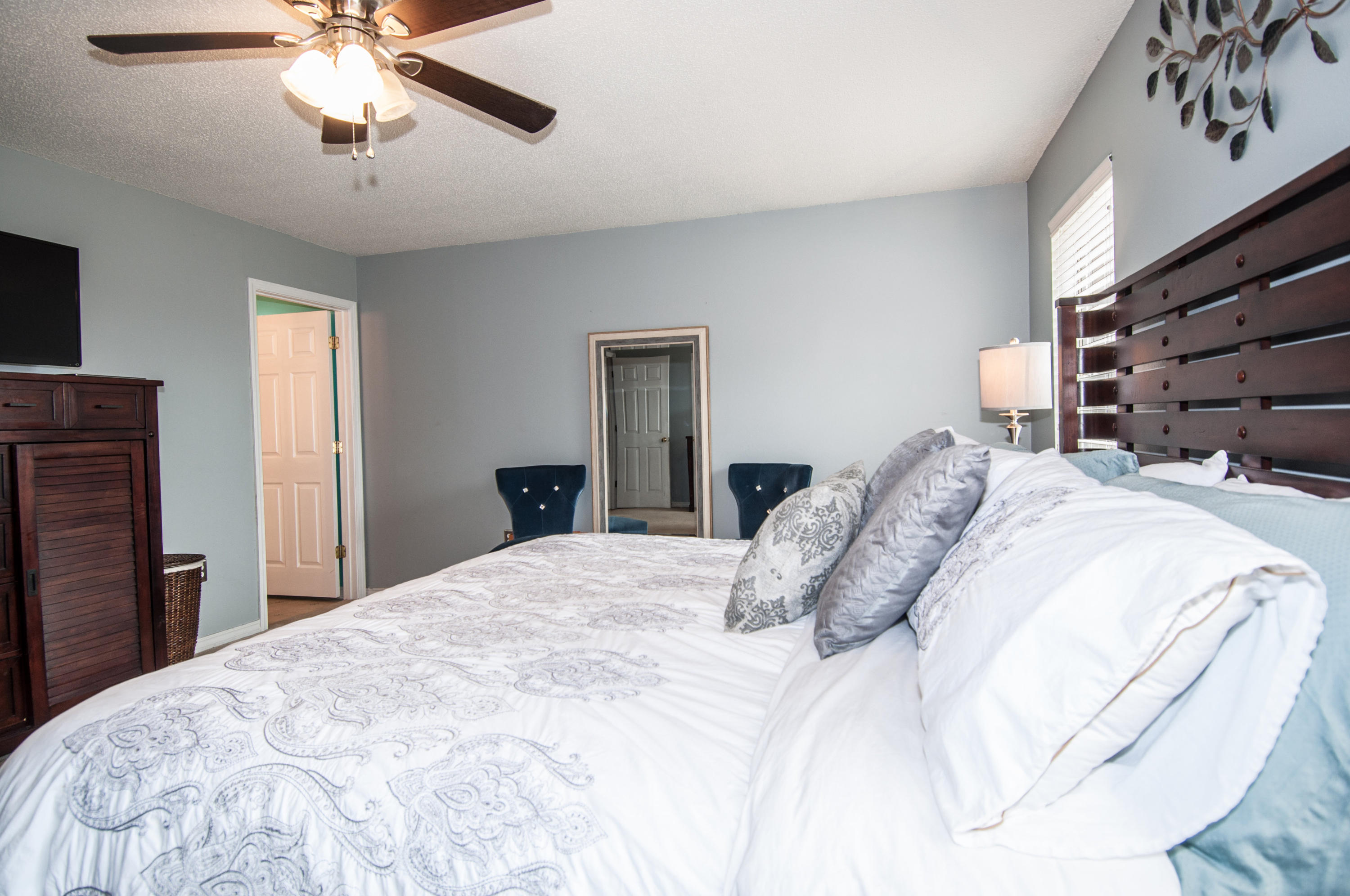 210 Limestone Circle Crestview, FL 32539 - Photo 39 of 54 a bedroom with a bed and a chandelier