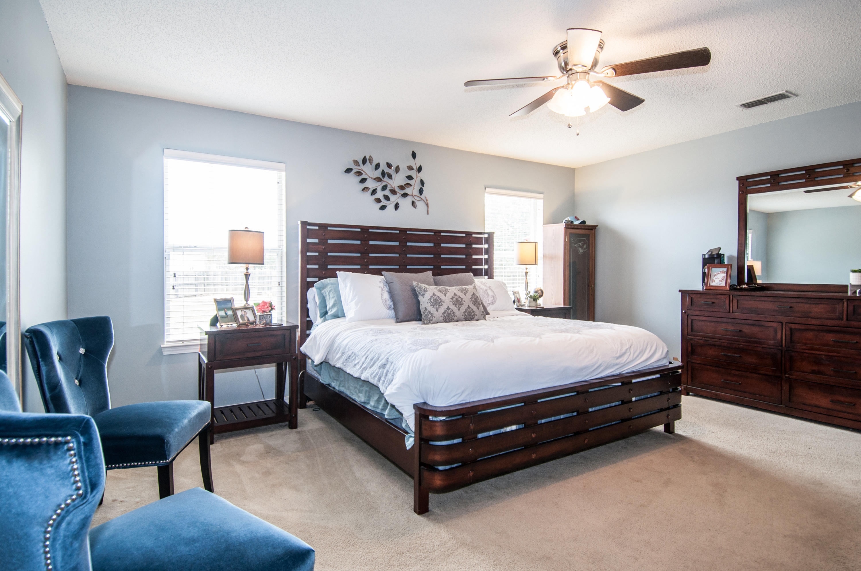 210 Limestone Circle Crestview, FL 32539 - Photo 42 of 54 a bedroom with a bed a chair and a chandelier