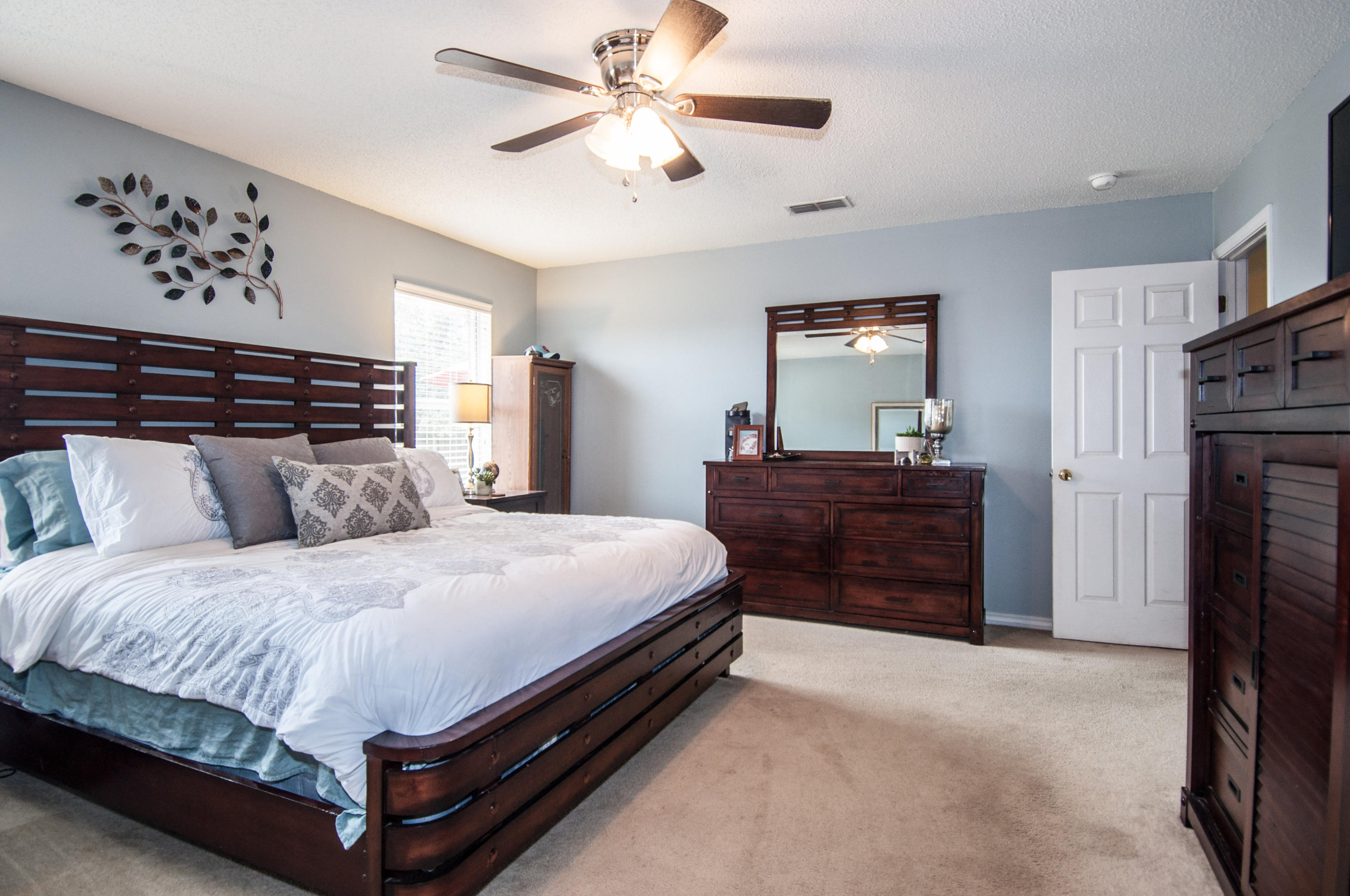 210 Limestone Circle Crestview, FL 32539 - Photo 43 of 54 a spacious bedroom with a bed and a chandelier