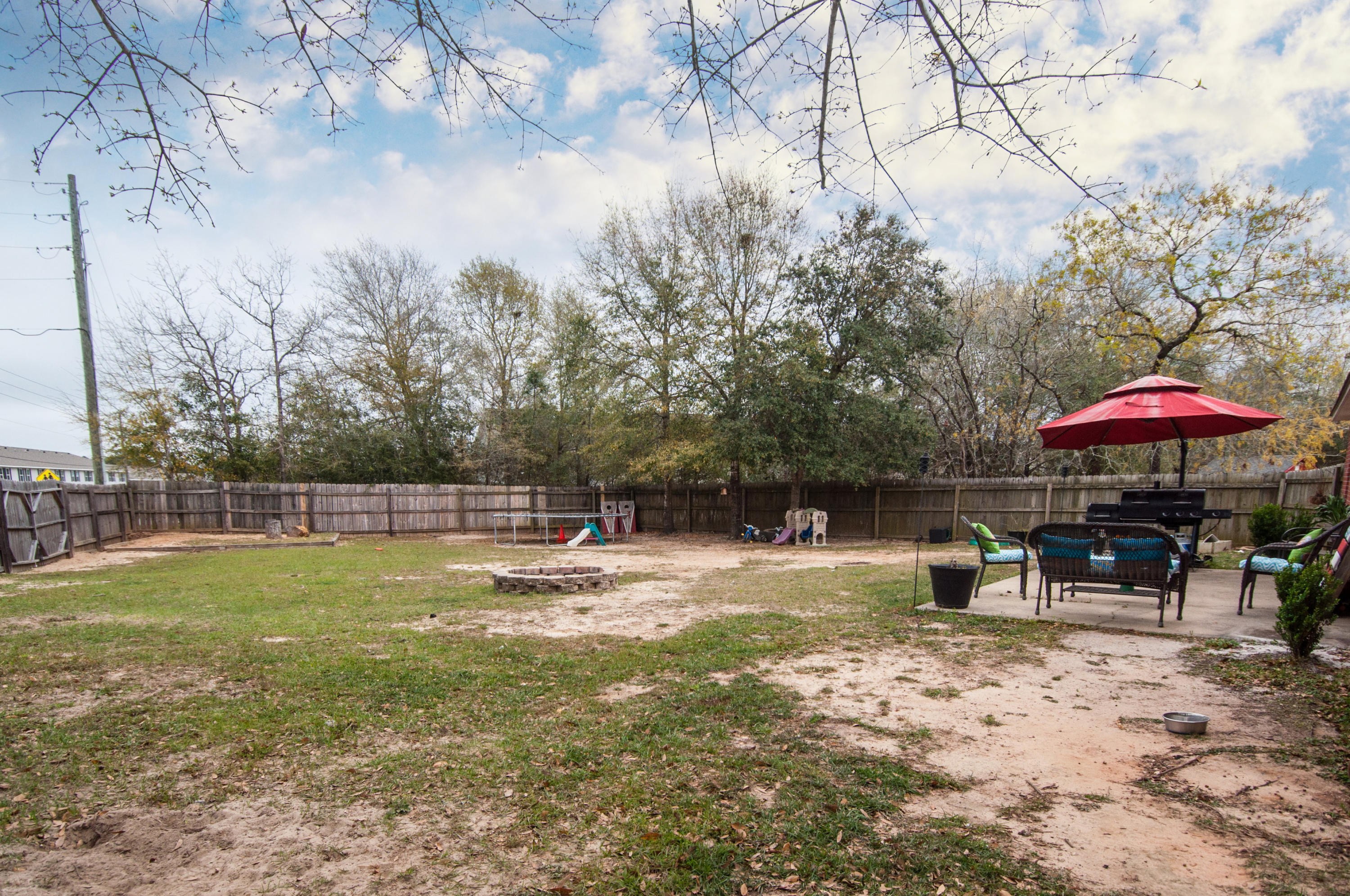 210 Limestone Circle Crestview, FL 32539 - Photo 52 of 54 a view of a backyard with a table and chairs