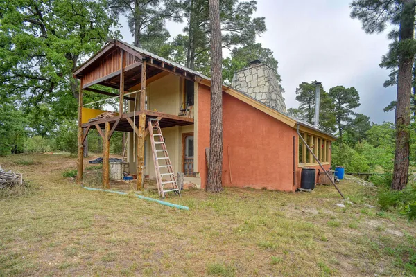 a view of a house with wooden fence