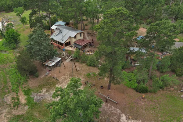 an aerial view of a house with a yard