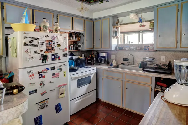 a kitchen with stainless steel appliances a white stove top oven sink and cabinets