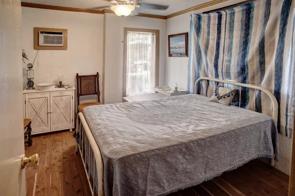a bed sitting in a bedroom next to a window