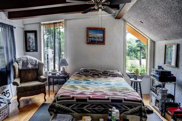 a bedroom with furniture and a window