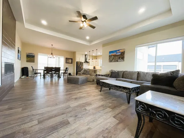 a living room with furniture and a chandelier