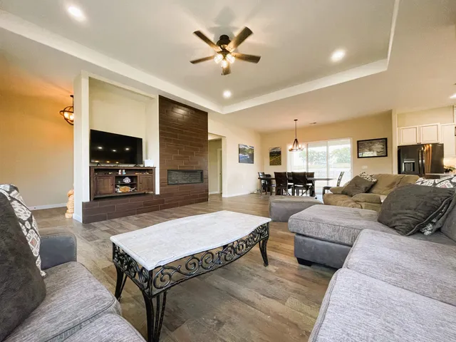 a living room with furniture a dining table and a fireplace