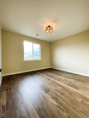 a view of an empty room and wooden floor