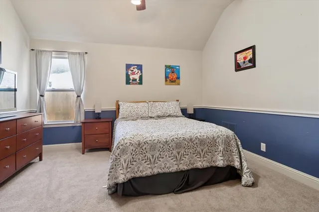 a bathroom with a granite countertop sink a toilet and shower