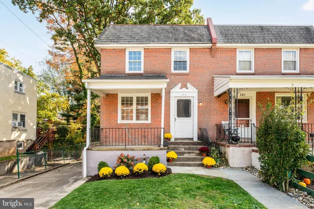 a view of a house with a backyard and sitting area