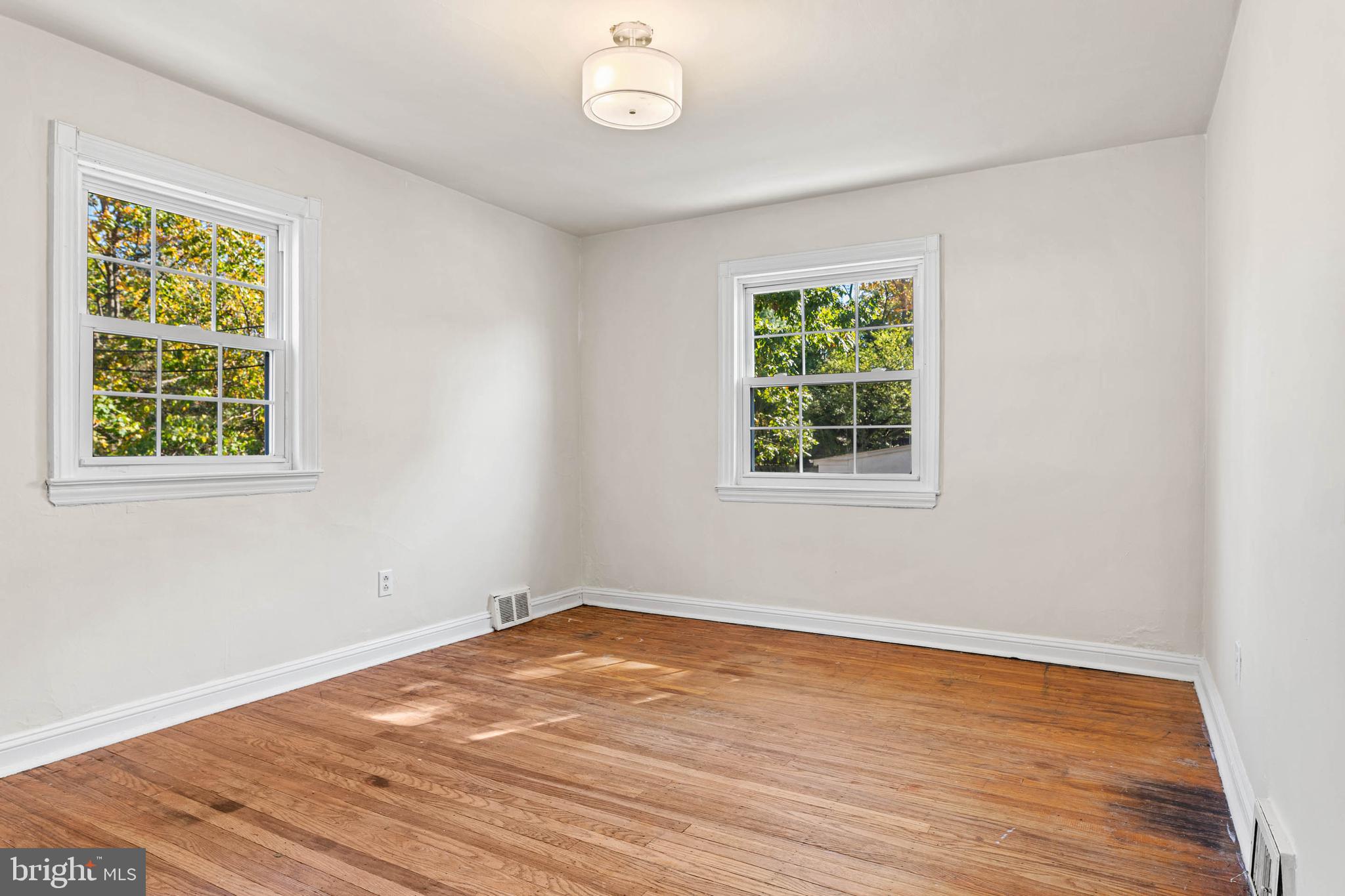 703 Humphreys Road Ardmore, PA 19003 - Photo 13 of 26 a view of a room with wooden floor and windows