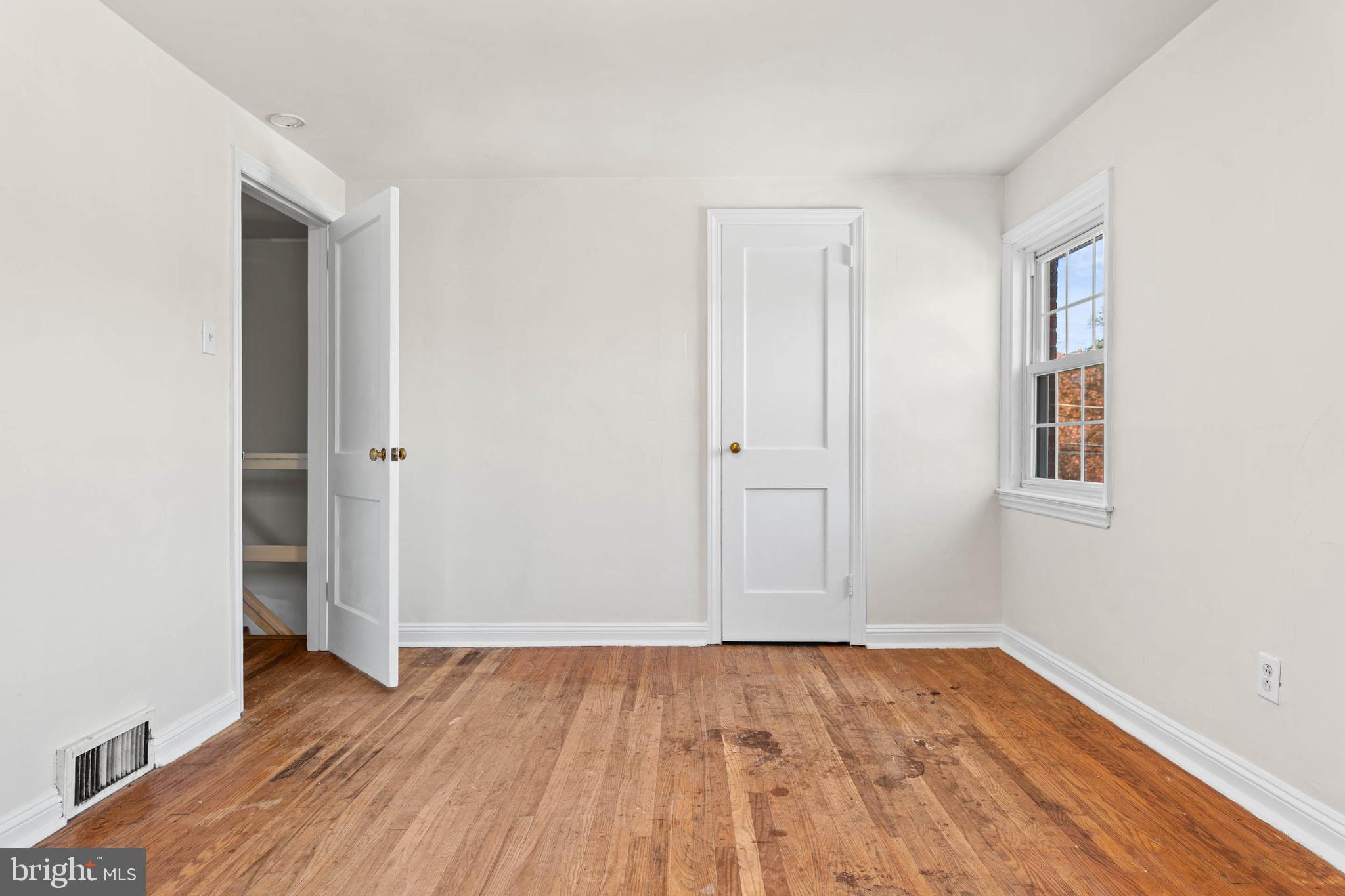 703 Humphreys Road Ardmore, PA 19003 - Photo 14 of 26 an empty room with wooden floor and closet
