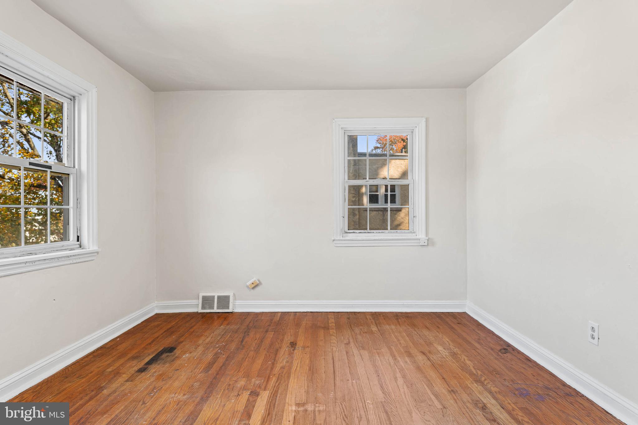 703 Humphreys Road Ardmore, PA 19003 - Photo 16 of 26 an empty room with a window and wooden floor