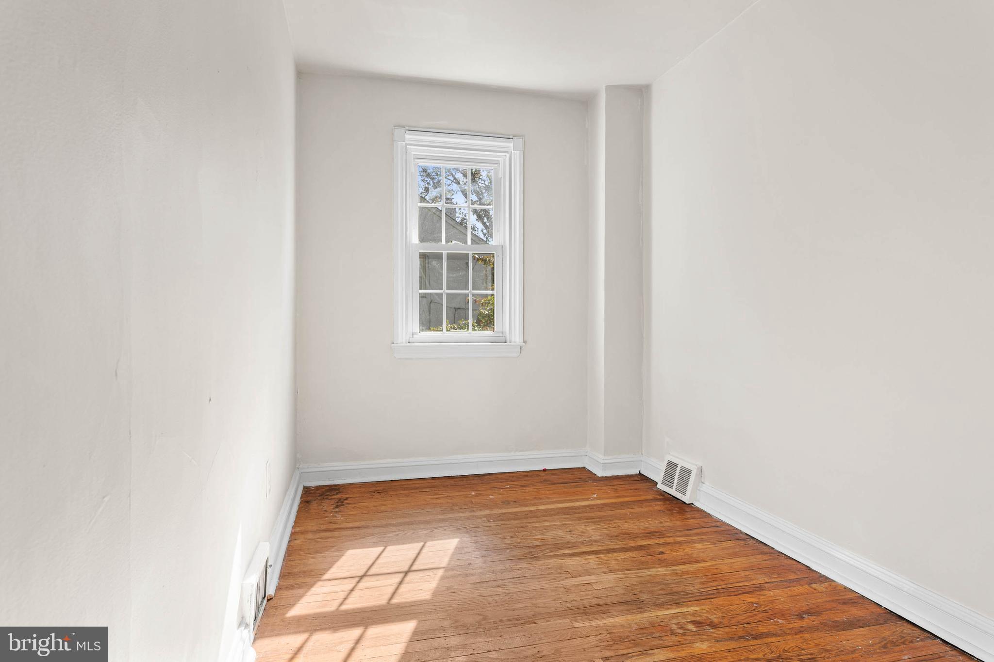 703 Humphreys Road Ardmore, PA 19003 - Photo 17 of 26 an empty room with wooden floor and windows