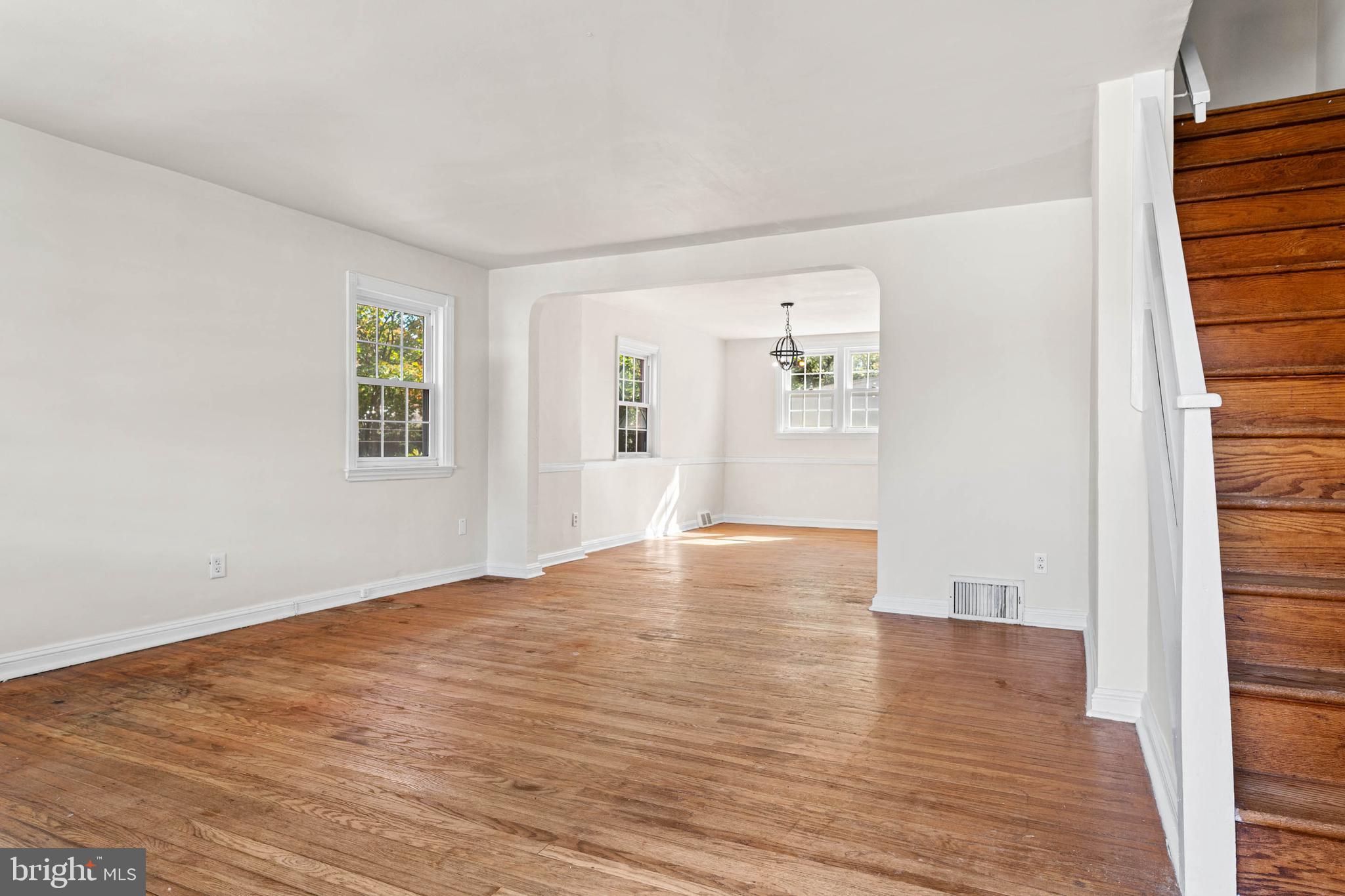 703 Humphreys Road Ardmore, PA 19003 - Photo 5 of 26 a view of an empty room with wooden floor and a window