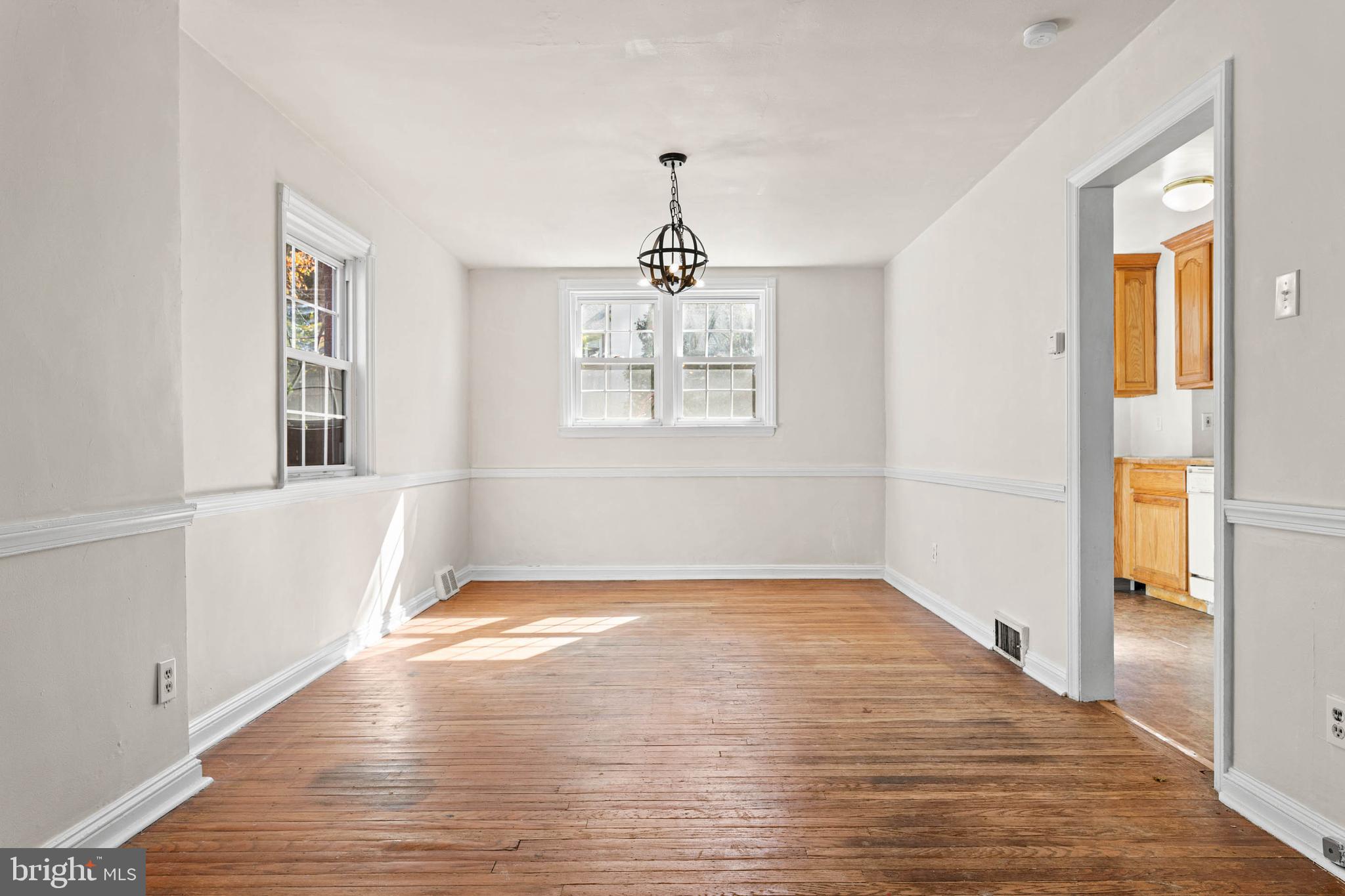 703 Humphreys Road Ardmore, PA 19003 - Photo 7 of 26 a view of an empty room with wooden floor and a window