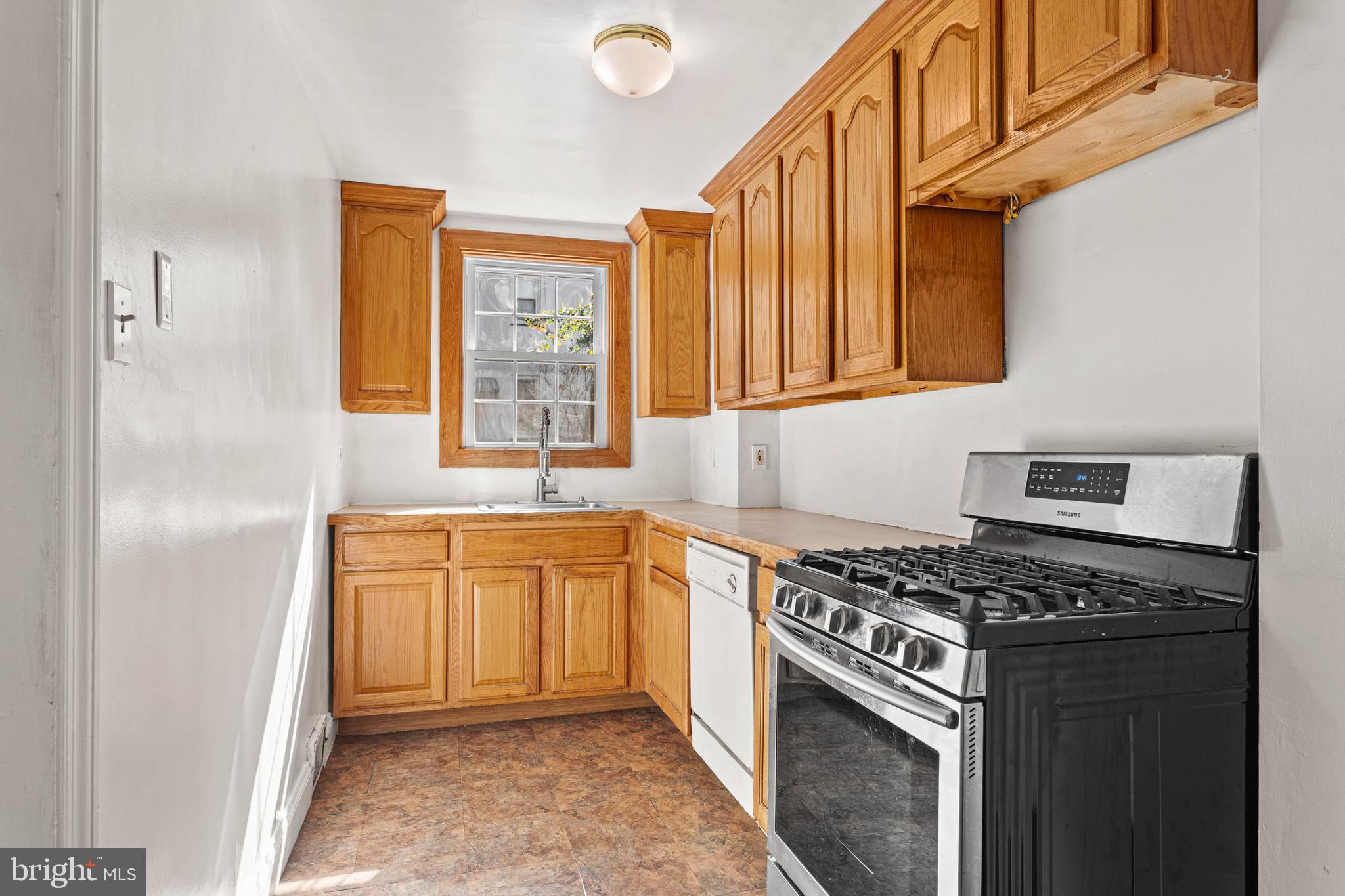 703 Humphreys Road Ardmore, PA 19003 - Photo 8 of 26 a kitchen with stainless steel appliances granite countertop a stove a sink and a refrigerator