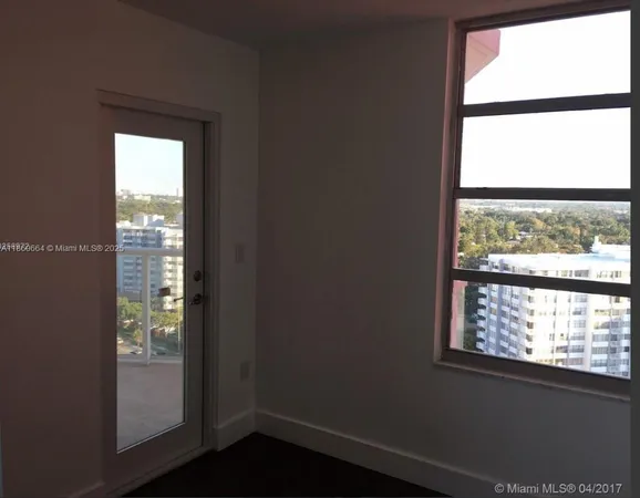 a view of an entryway with wooden floor and a window