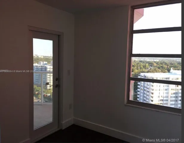 a view of an entryway with wooden floor and a window