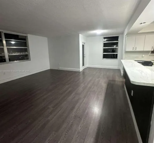 a kitchen with granite countertop a stove and a refrigerator
