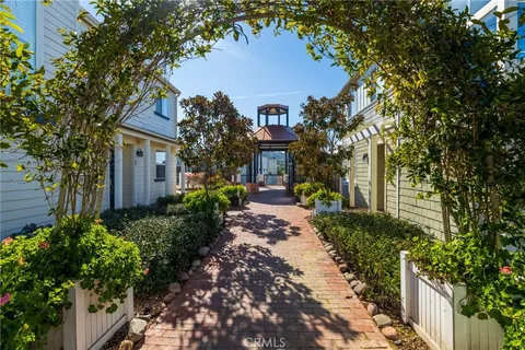 a front view of a house with garden and trees