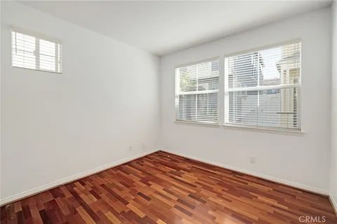 a view of a room with wooden floor and windows