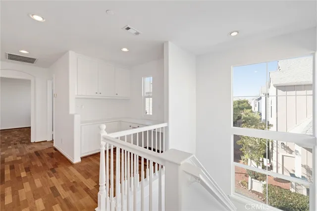 a view of hallway with windows and stairs