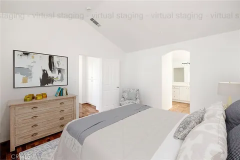 a bedroom with a bed and a dresser in it