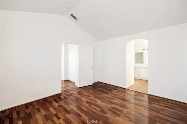 a view of a room with wooden floor and closet