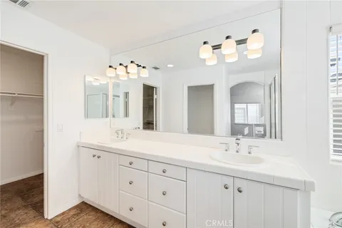 a bathroom with a sink vanity and a mirror
