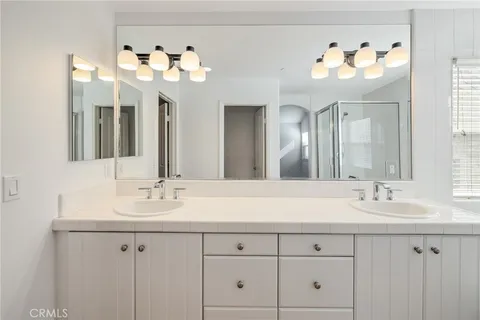 a bathroom with a sink vanity and a mirror
