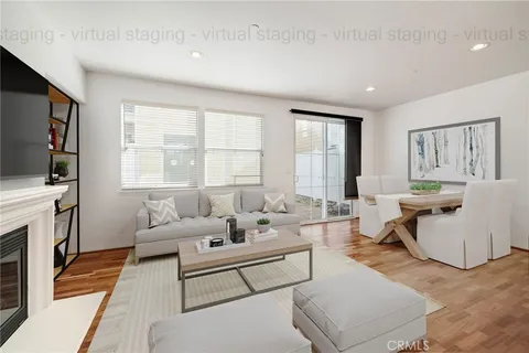 a living room with furniture a flat screen tv and a window