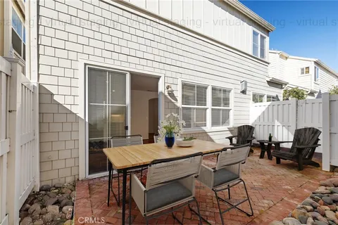 a table and chairs sitting in front of a house