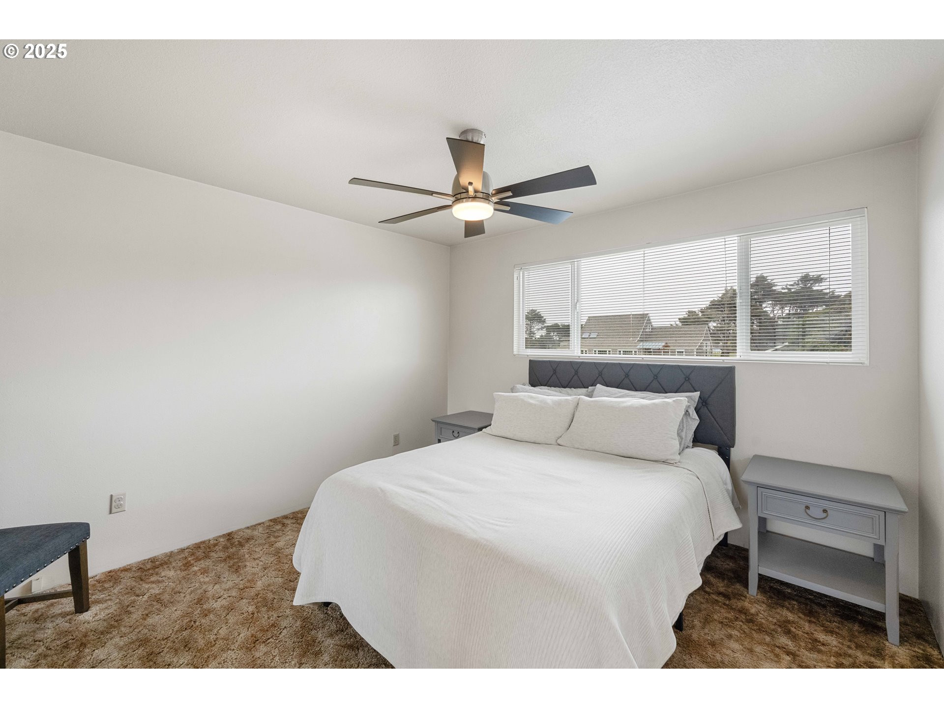 875 Ocean Drive Southwest Bandon, OR 97411 - Photo 11 of 31 a bedroom with a bed and a window