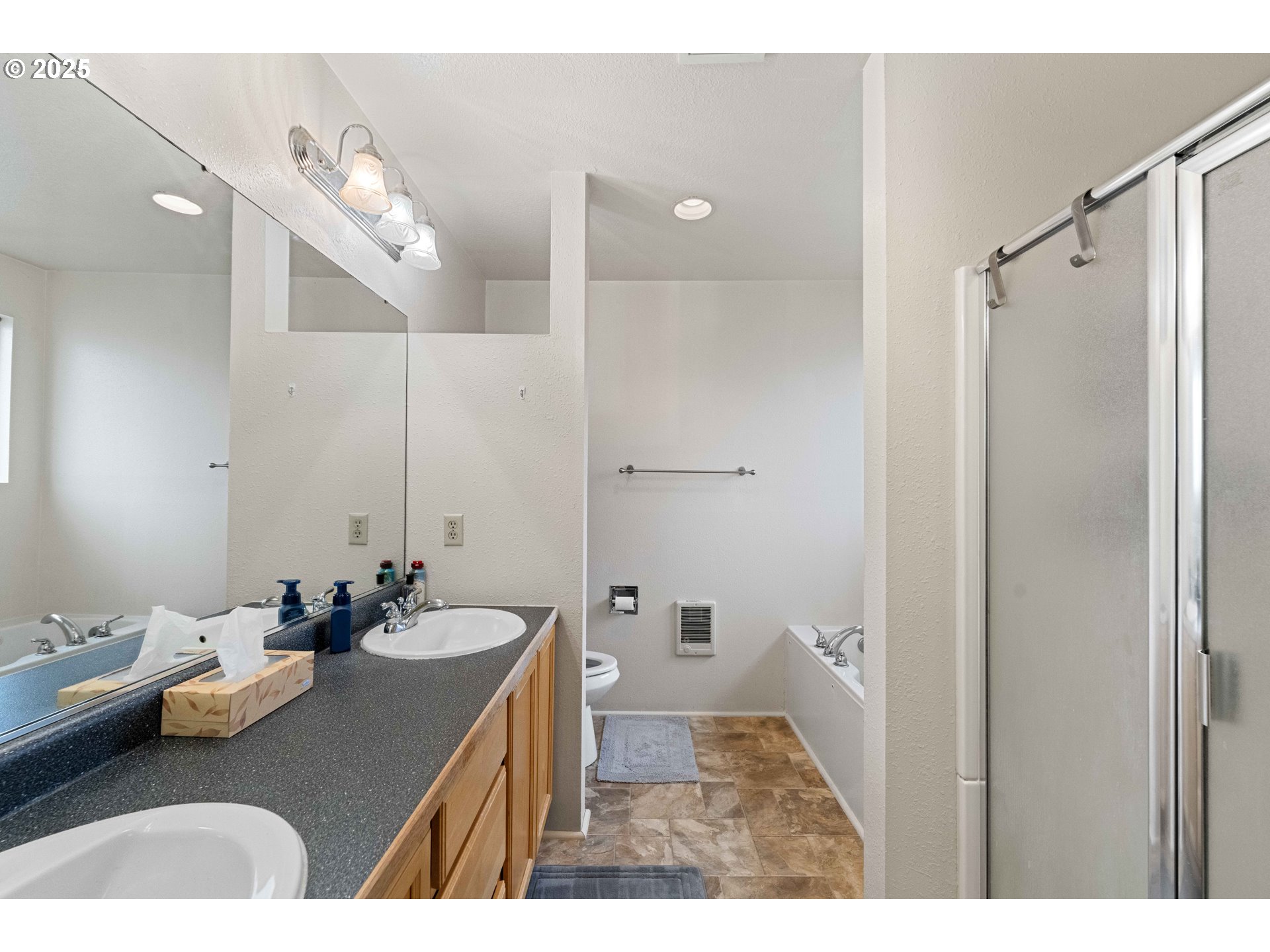 875 Ocean Drive Southwest Bandon, OR 97411 - Photo 12 of 31 a bathroom with a sink vanity granite tub and shower