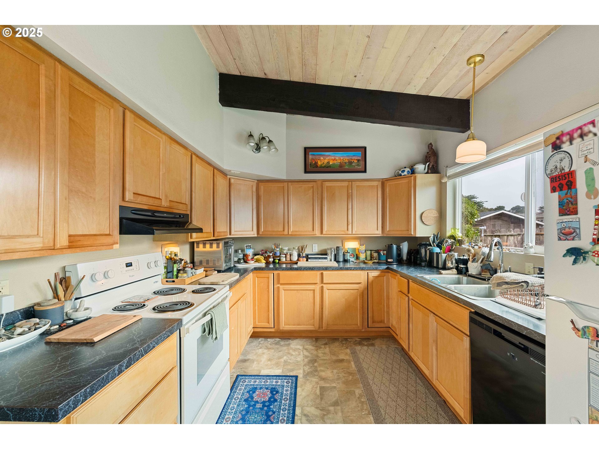 875 Ocean Drive Southwest Bandon, OR 97411 - Photo 19 of 31 a kitchen with stainless steel appliances a sink a stove top oven a sink a counter space and cabinets
